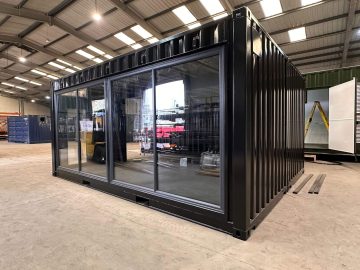 A bespoke custom shipping container build project with fitted windows, and electrics, finished with a fresh coat of two pack black paint.